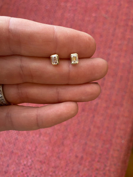 14 k gold bezel set emerald cut diamond studs