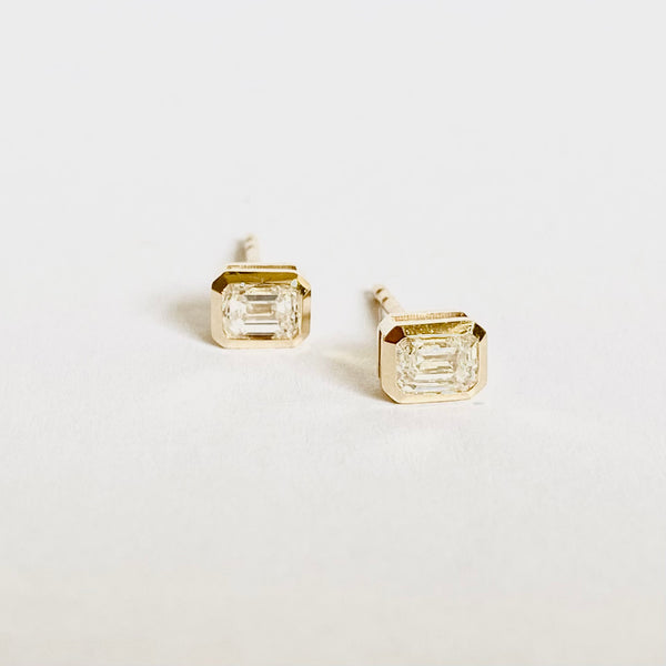 14 k gold bezel set emerald cut diamond studs