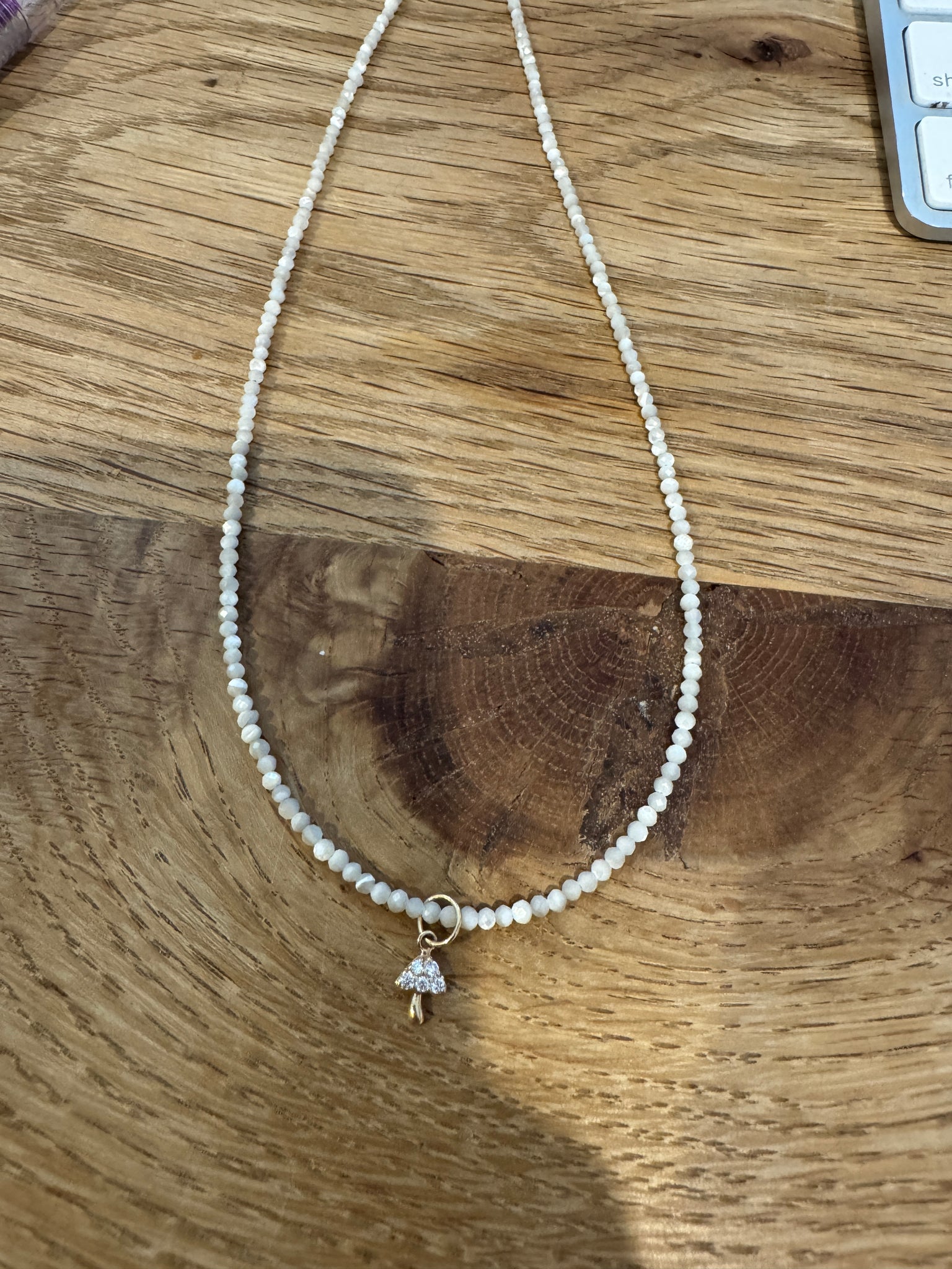 delicate mother of pearl necklace with mushroom charm