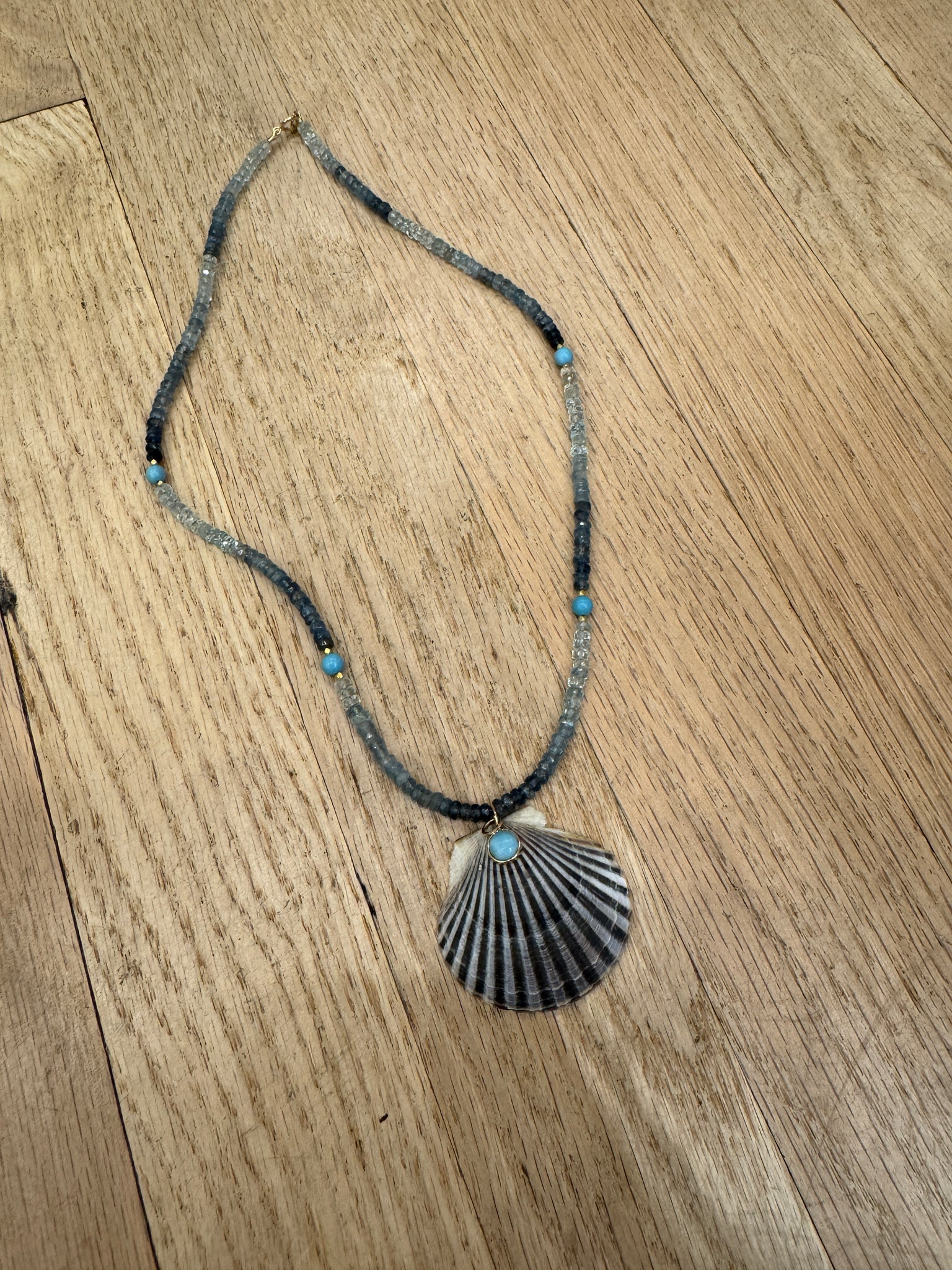 shaded blue sapphire necklace with shell pendant