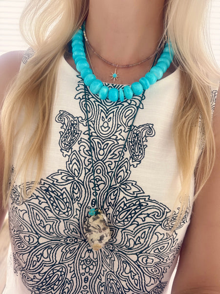 Turquoise starburst on Zircon, pearl, and turquoise Turquoise starburst on zircon, pearl, and turquoise