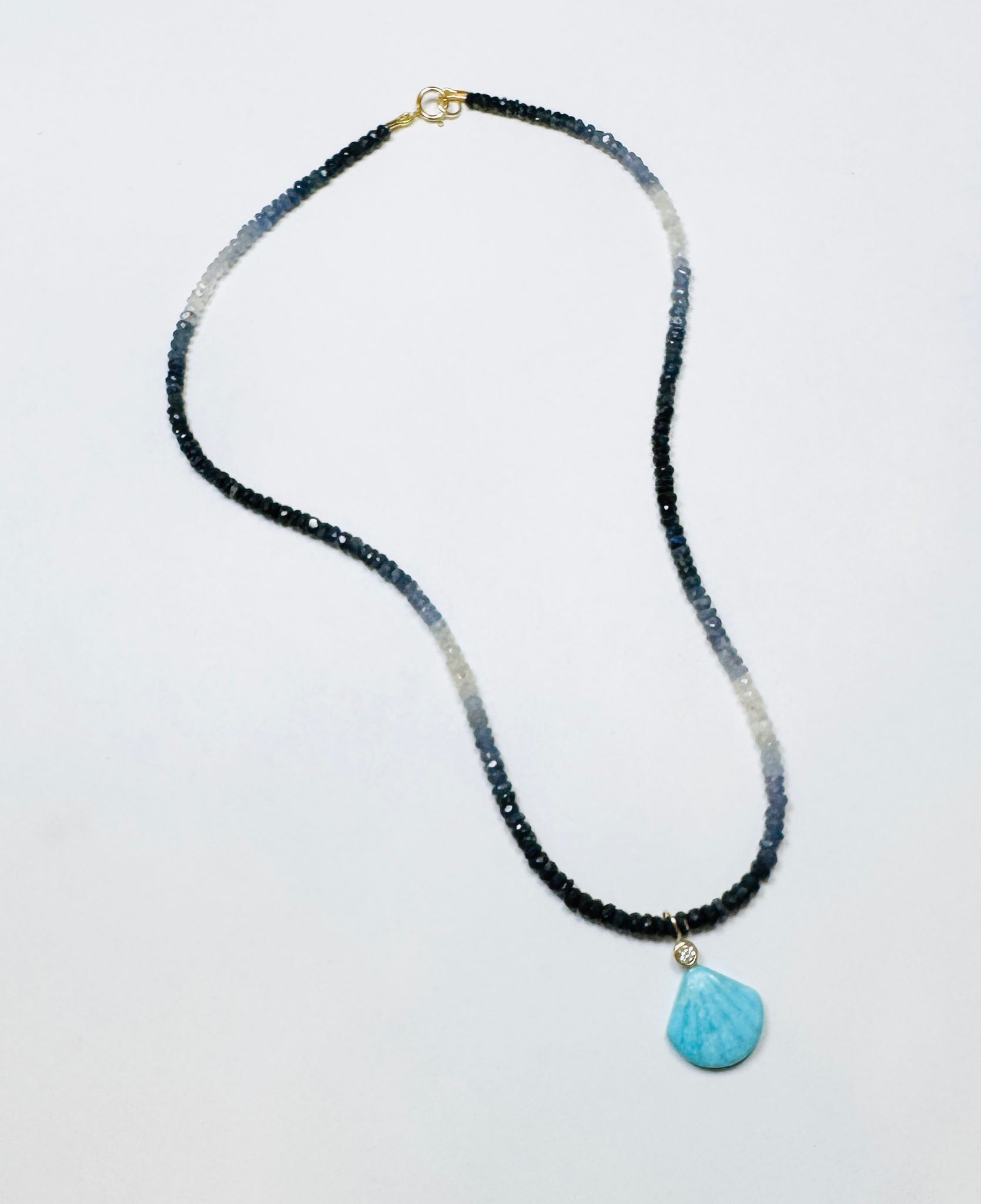 turquoise bezel diamond shell pendant on shaded blue sapphire