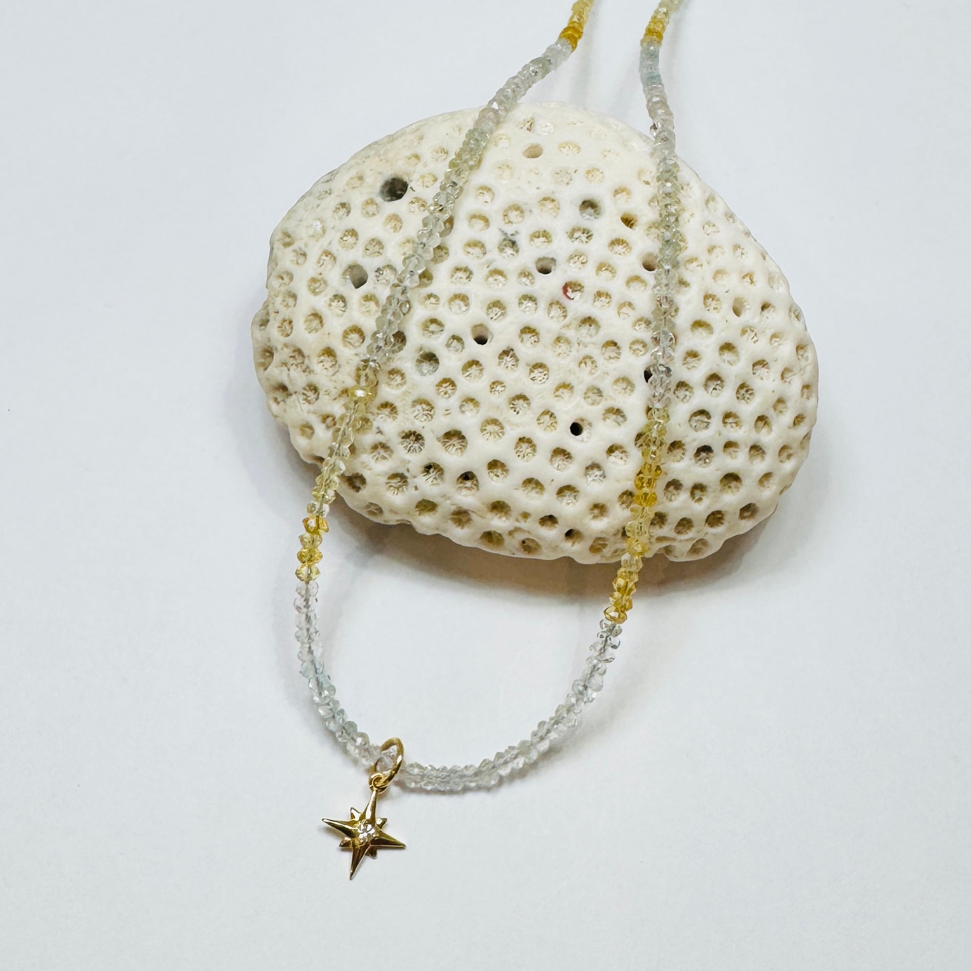 delicate aquamarine necklace with starburst charm
