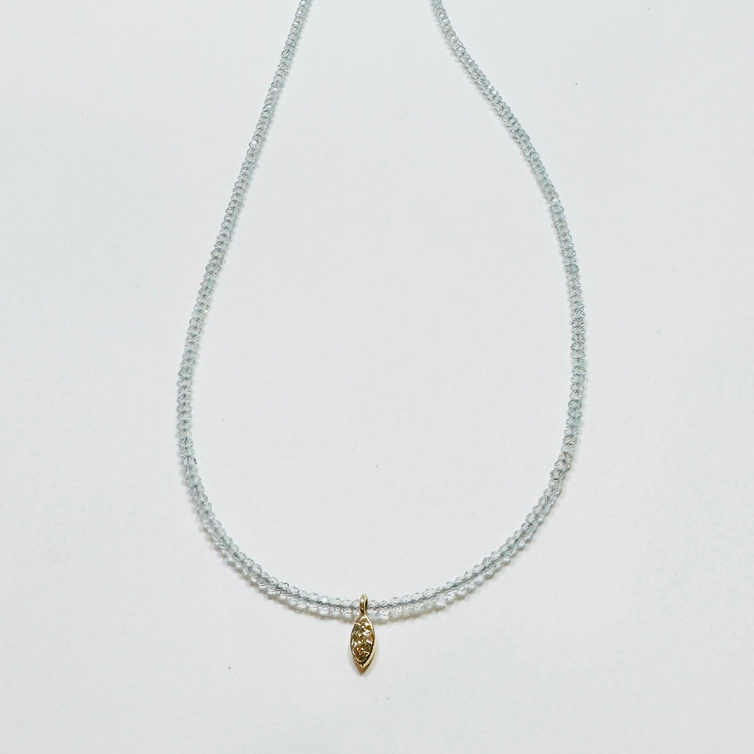 delicate topaz necklace with diamond charm