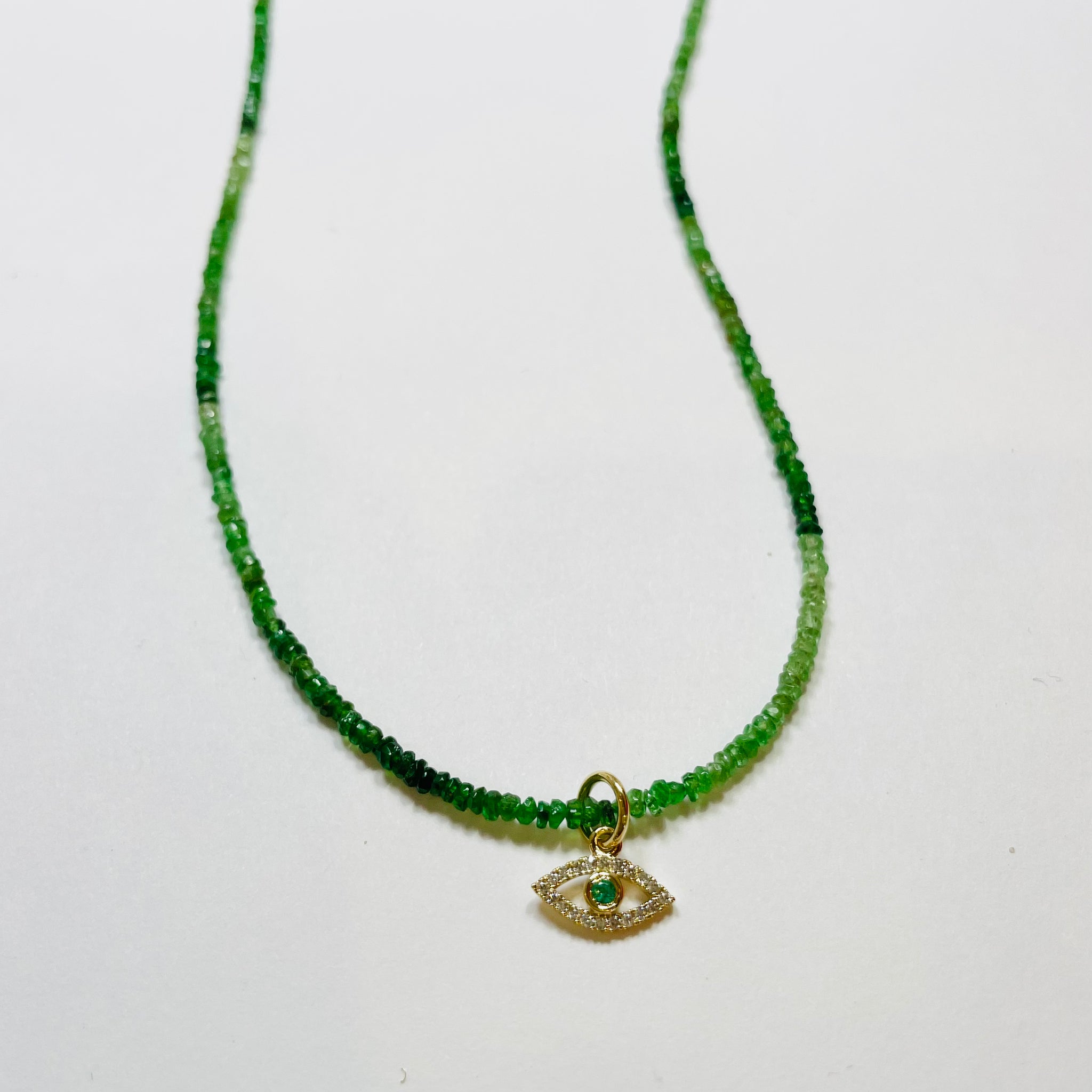 delicate emerald necklace with evil eye charm