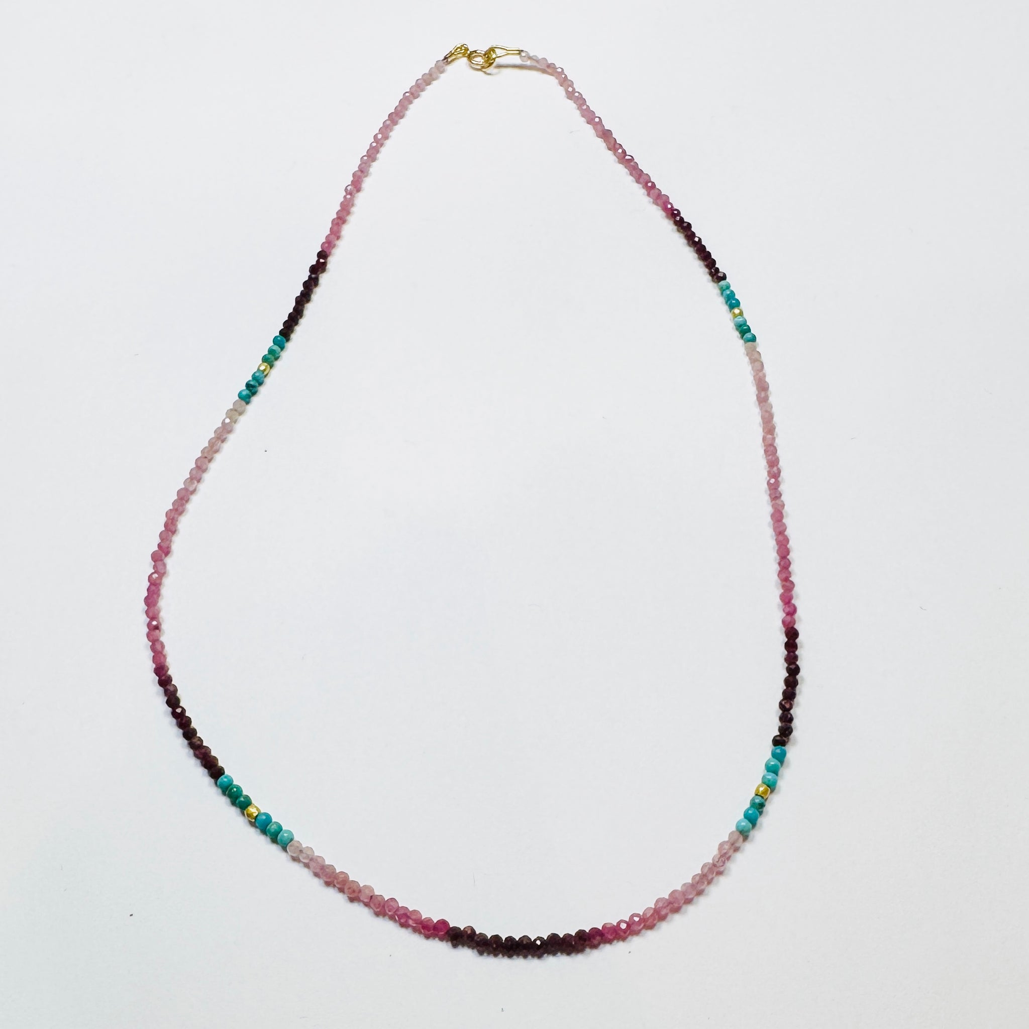 delicate shaded ruby necklace with turquoise and gold nuggets