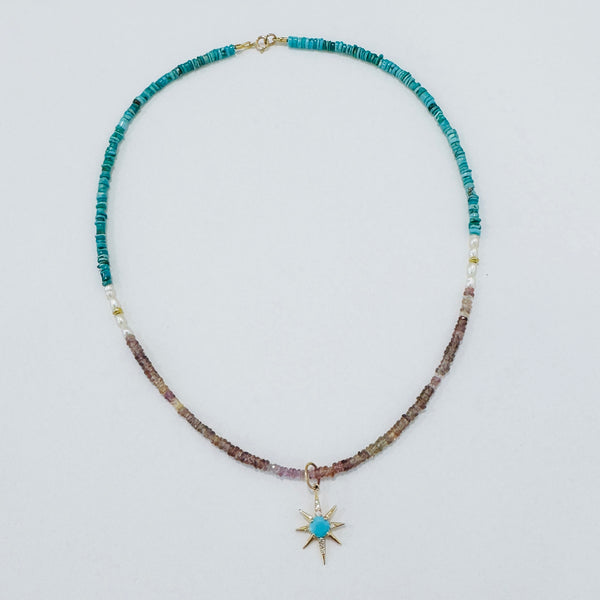 Turquoise starburst on Zircon, pearl, and turquoise Turquoise starburst on zircon, pearl, and turquoise