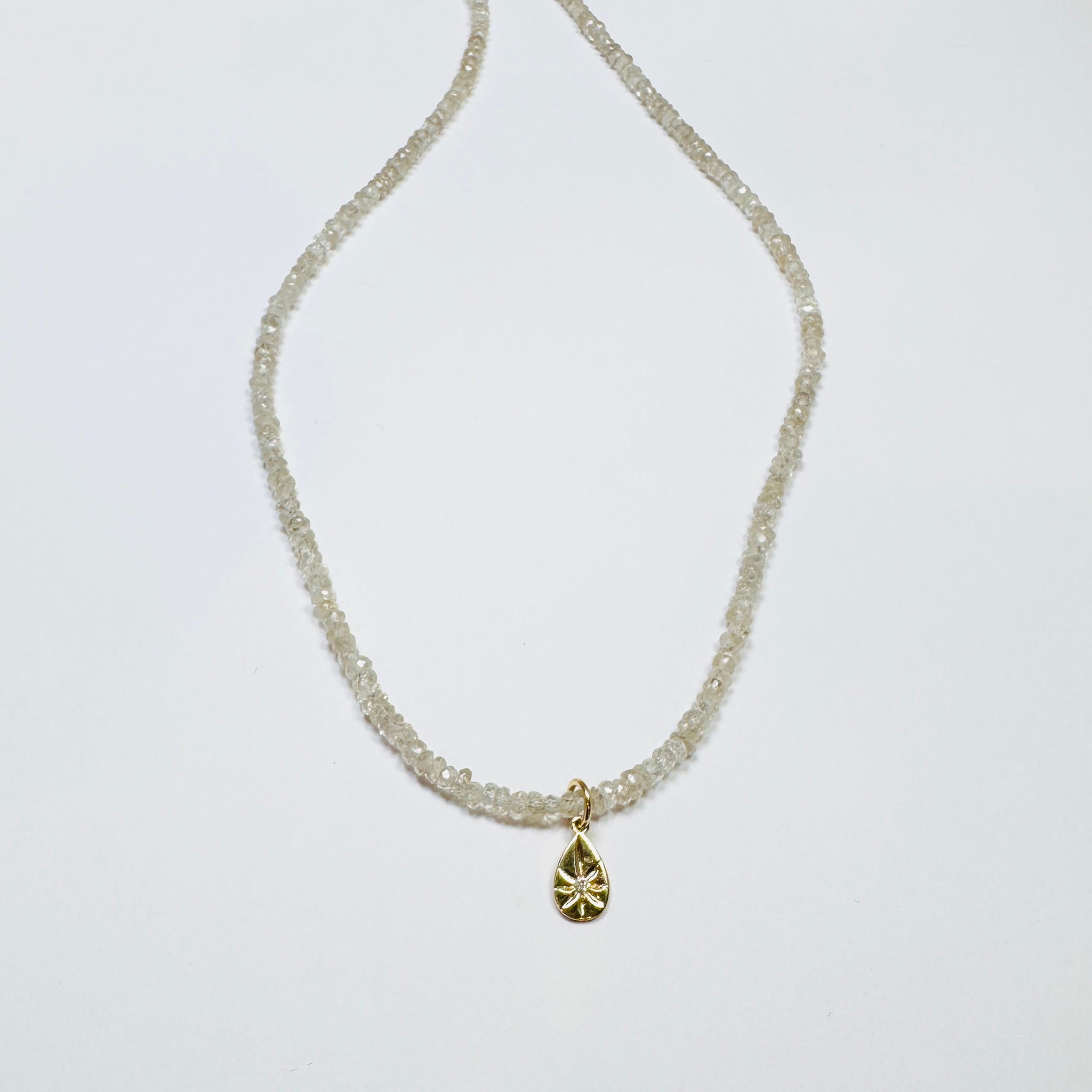 gemstone chain with diamond and gold teardrop