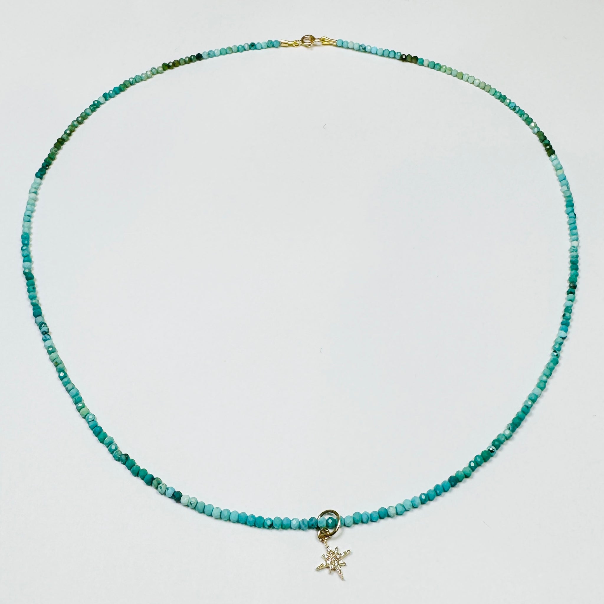 delicate turquoise necklace with diamond starburst charm