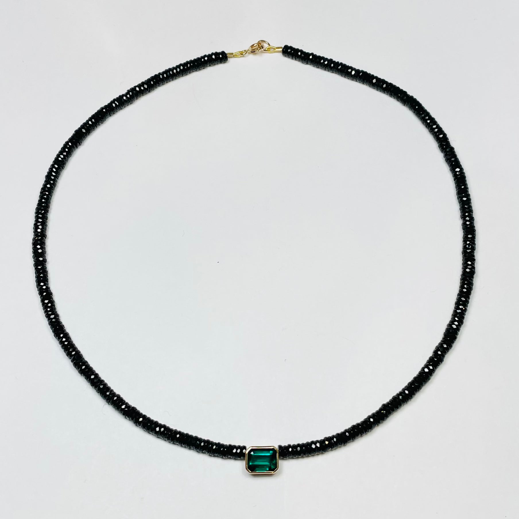 black spinel heishi necklace with bezel emerald