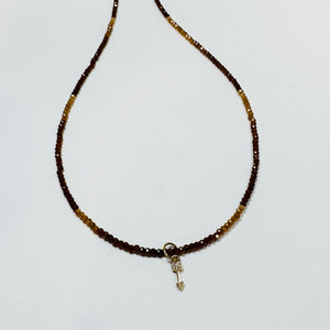 delicate hessonite necklace with arrow charm