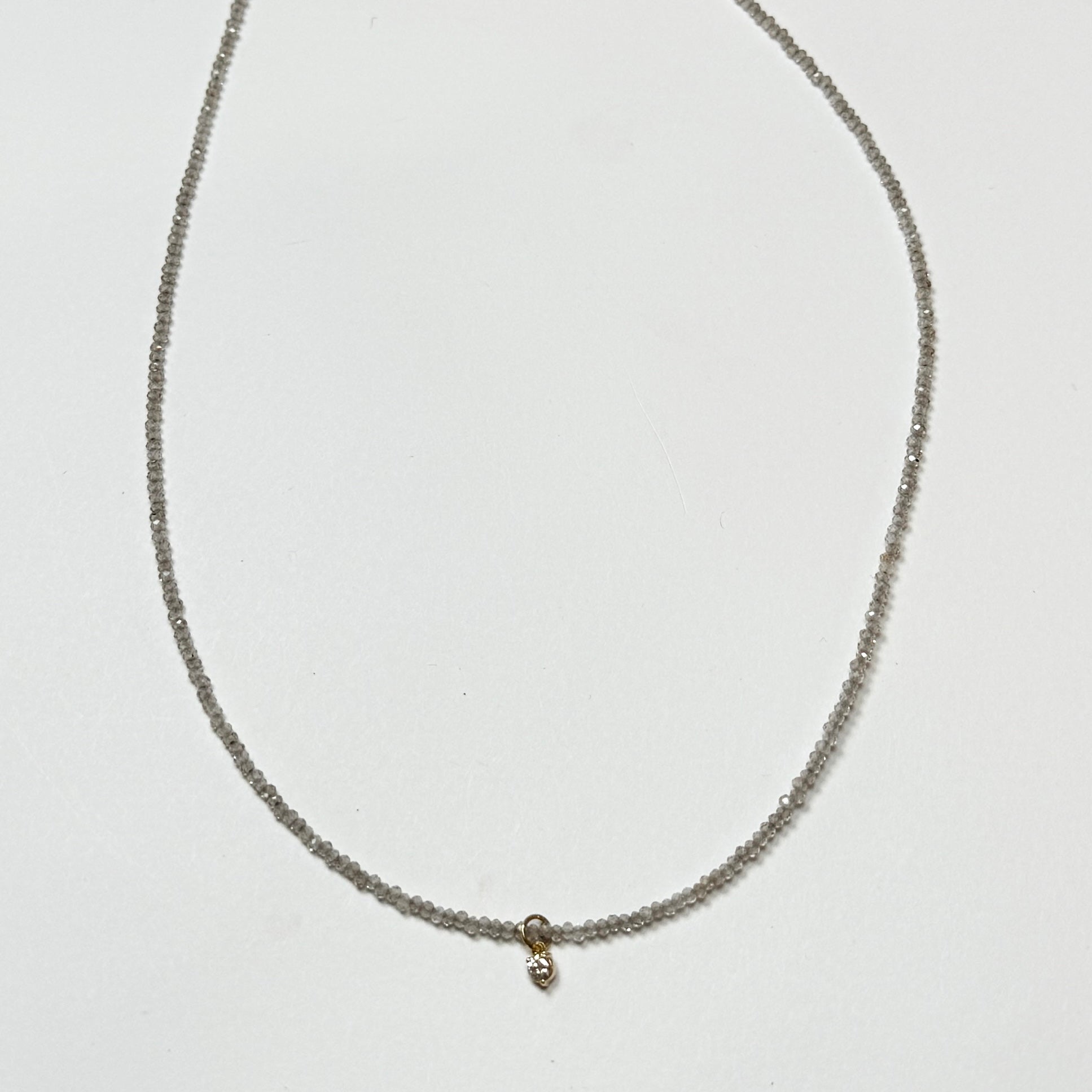 delicate necklace with prong set diamond