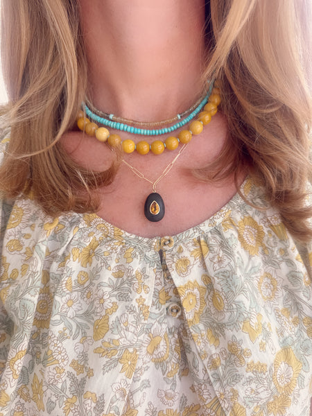 bezel set teardrop citrine on wood