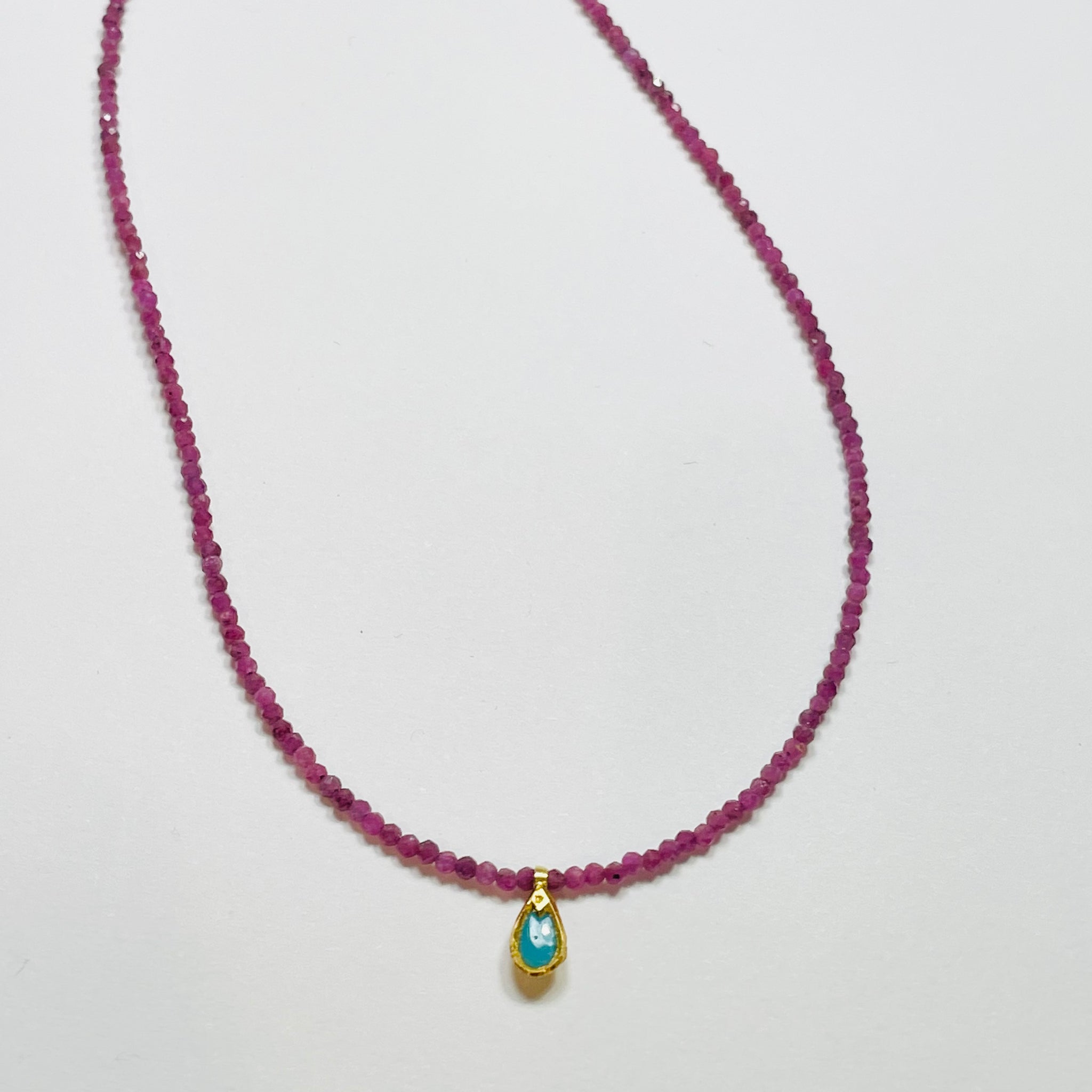 delicate ruby necklace with turquoise charm