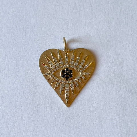 gold and diamond heart pendant with sapphire evil eye