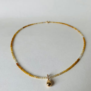 Yellow sapphires with gold teardrop pendant